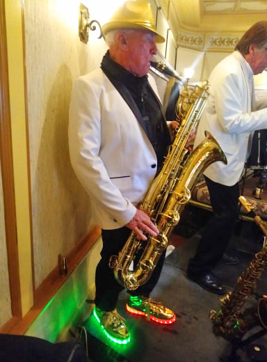 Saxophone player with green stage lighting