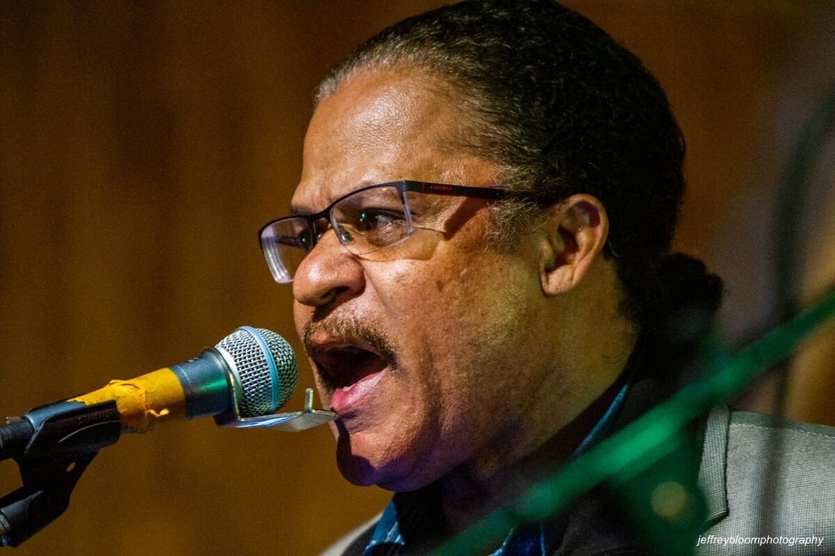 Saxophone player with gold fedora singing